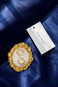 Ornate gold-plated statement earrings with an ivory centre, designed to embody timeless elegance and refined vintage charm.