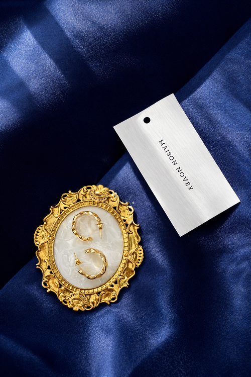 Ornate gold-plated statement earrings with an ivory centre, designed to embody timeless elegance and refined vintage charm.